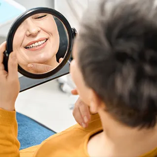 Looking at dentures in mirror